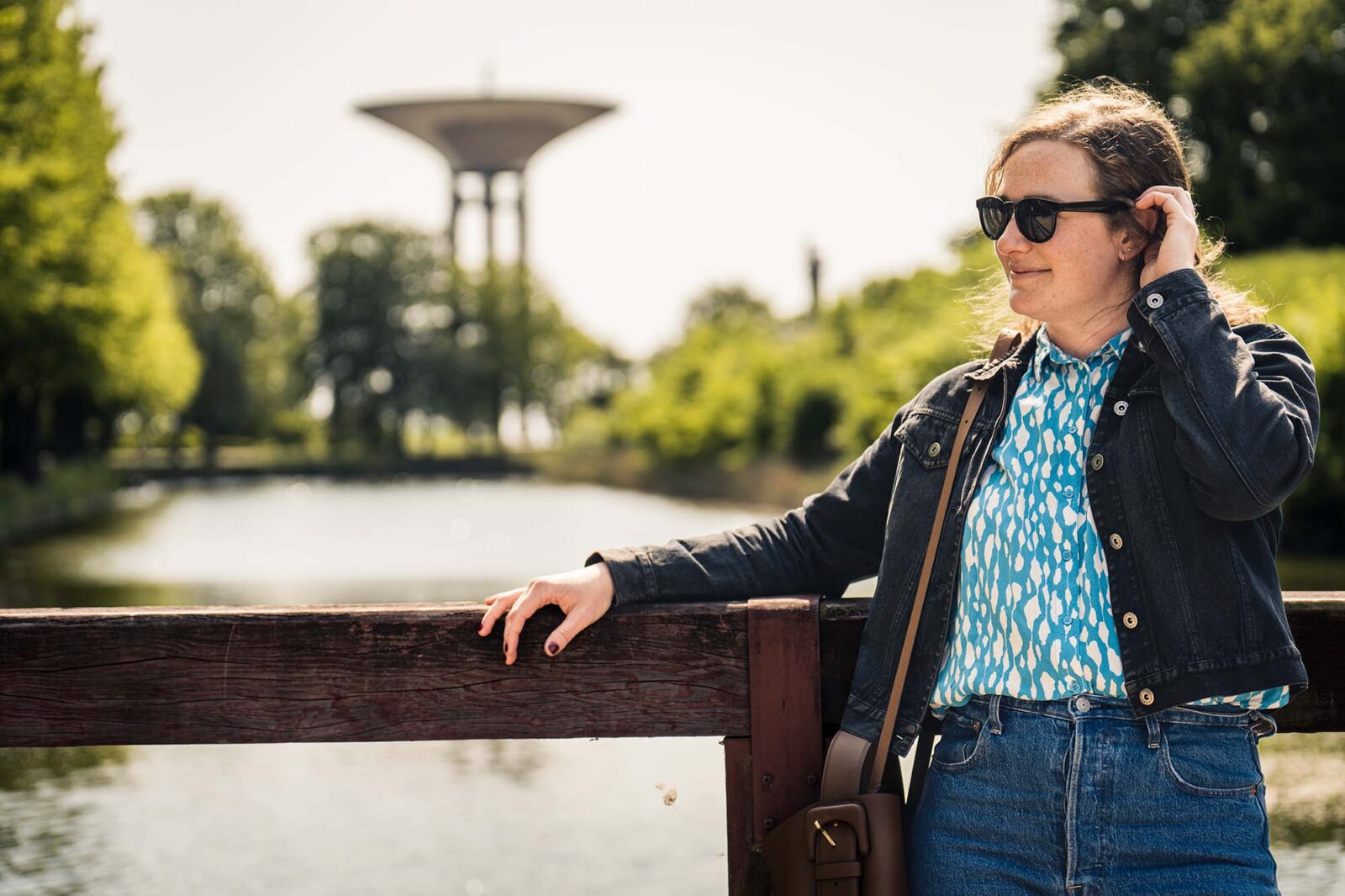 Woman standing on a bridge in a town prak