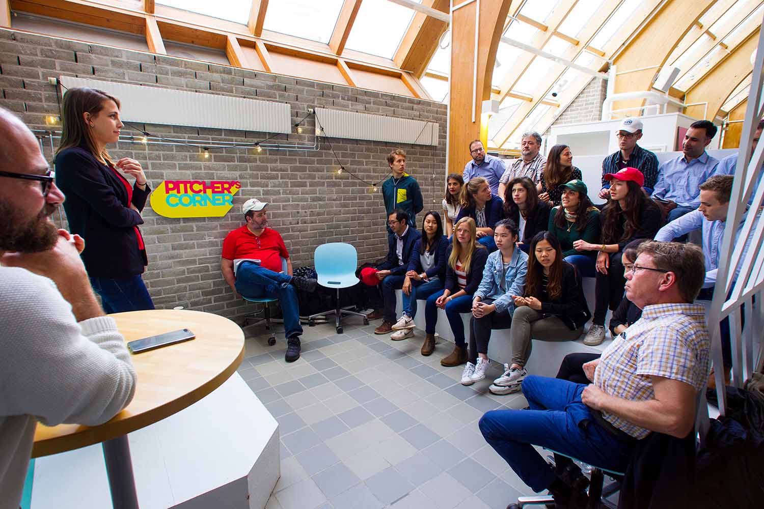 A croup of people listening to a speaker