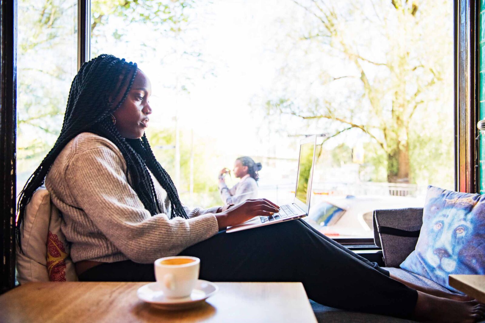 Girl working with her laptop at a cafe