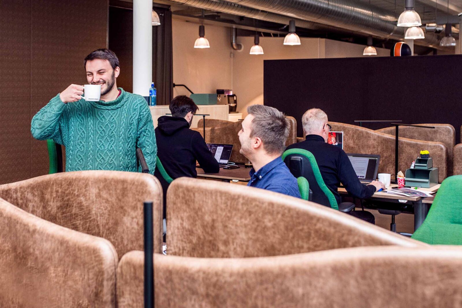 A office environment where colleagues interact with eachother